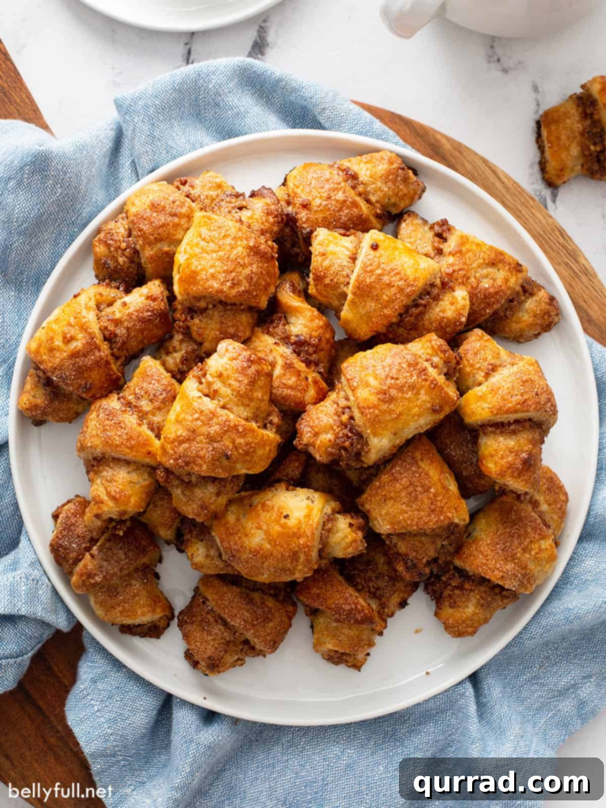 An overhead shot showcasing a beautiful display of Rugelach cookies piled high on an elegant serving tray, ready to be enjoyed.