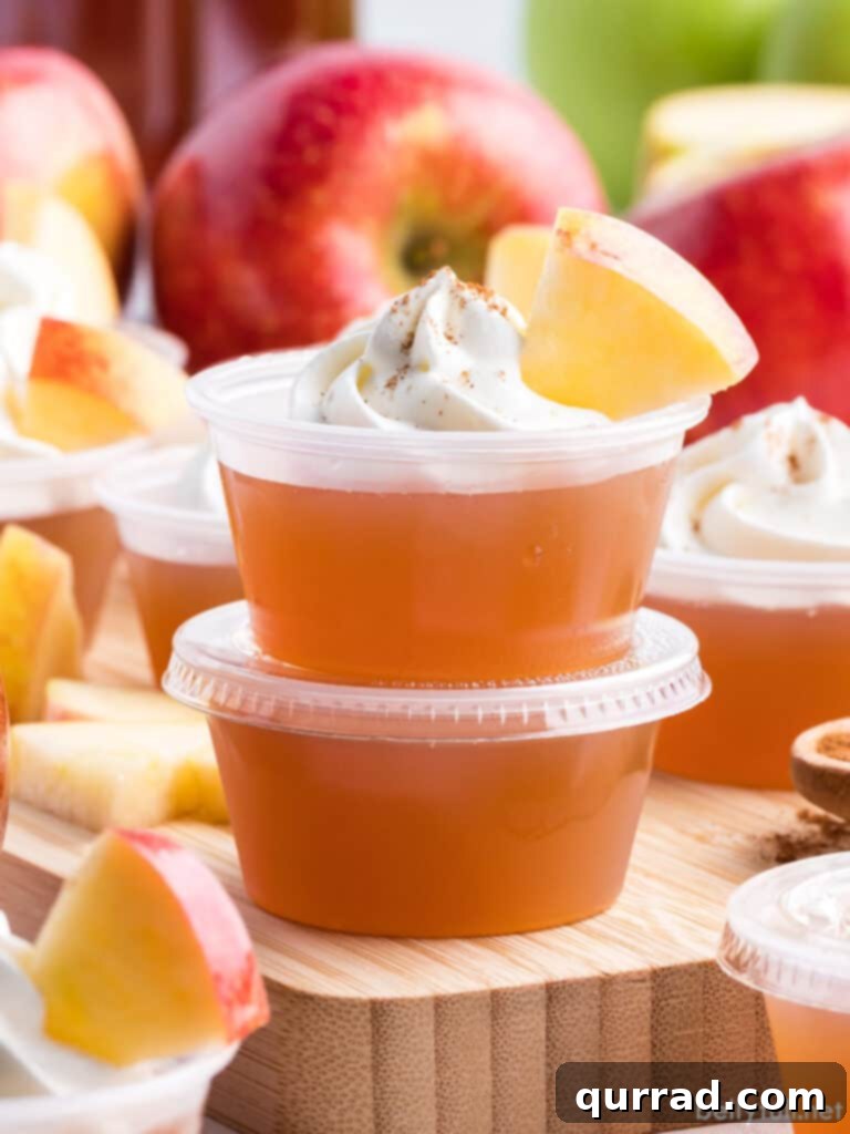 Boozy Apple Pie Jellies 4 Two stacked apple jello shots with whipped cream and cinnamon