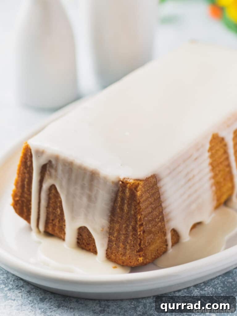 Zesty Lemon Bliss Loaf 3 A perfectly baked loaf of lemon pound cake, beautifully coated in a smooth, sweet vanilla and lemon icing.
