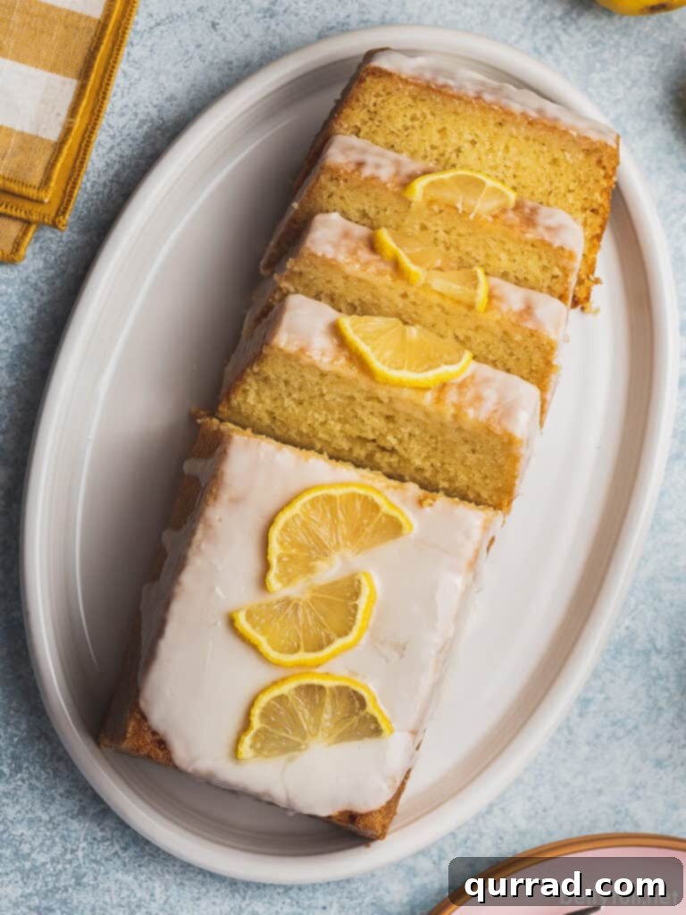 Zesty Lemon Bliss Loaf 4 An overhead view of a beautifully iced lemon loaf pound cake, elegantly garnished with thin, fresh lemon slices.