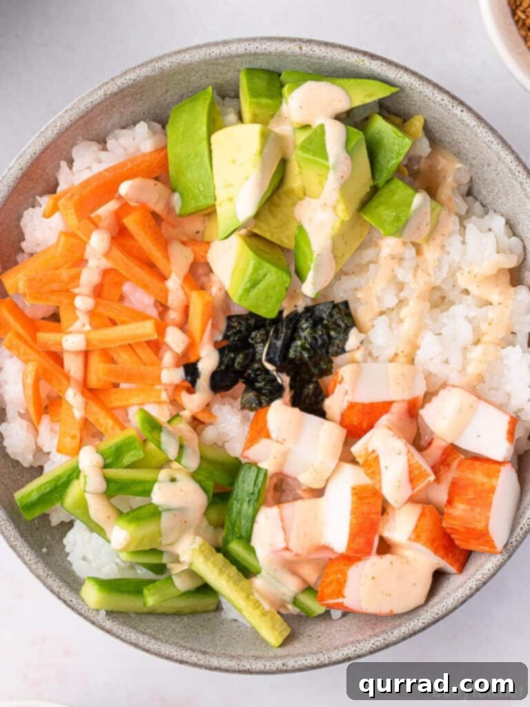 Deconstructed California Roll Bowls 2 Close-up overhead view of a colorful California Roll Sushi Bowl with carrots, cucumber, avocado, and imitation crab