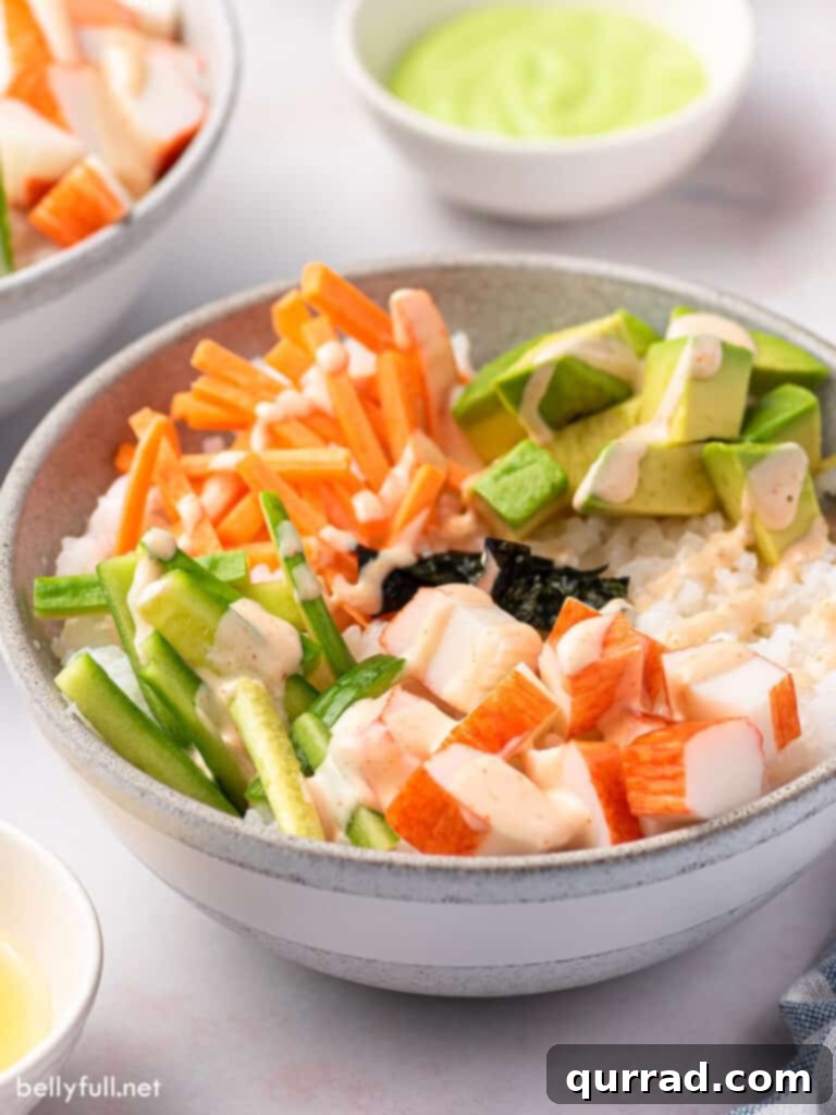 Deconstructed California Roll Bowls 5 Side angle view of a deconstructed California Roll in a bowl, showcasing layers of ingredients