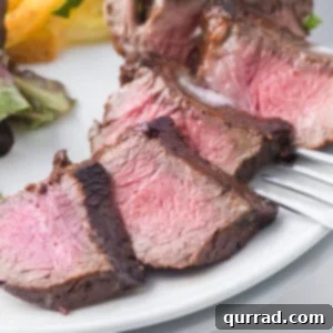 Slices of steak in easy steak marinade on a plate with French fries