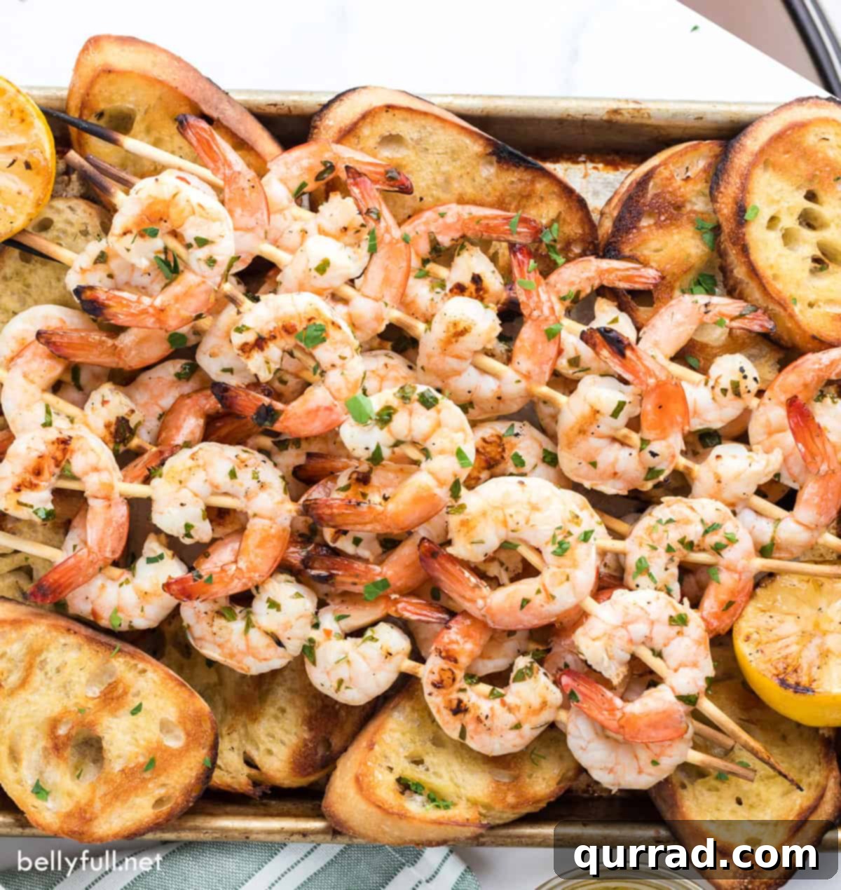 Flame-Kissed Shrimp Scampi 5 Grilled shrimp skewers on top of grilled baguette slices