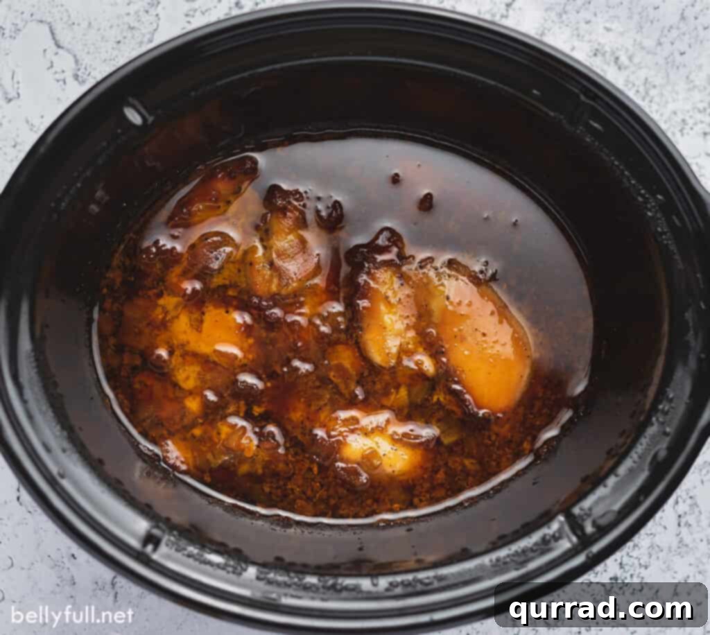 Sweet and Sticky Honey Garlic Chicken 4 overhead chicken and sauce in slow cooker