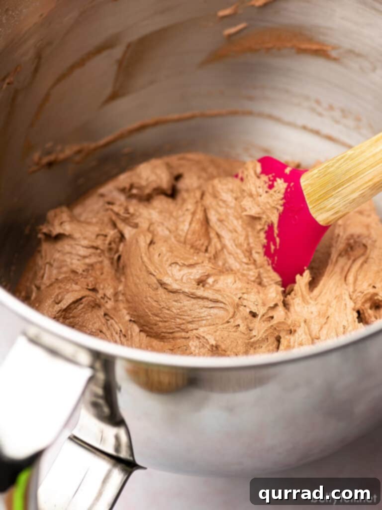 Rich and Creamy Chocolate Frosting 4 chocolate frosting in a bowl of a stand mixer with spatula