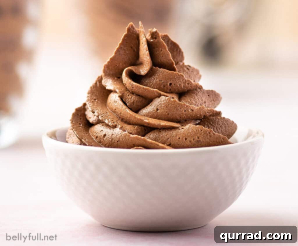 Rich and Creamy Chocolate Frosting 5 chocolate buttercream frosting piped in a white bowl
