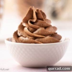 chocolate buttercream frosting piped in a white bowl