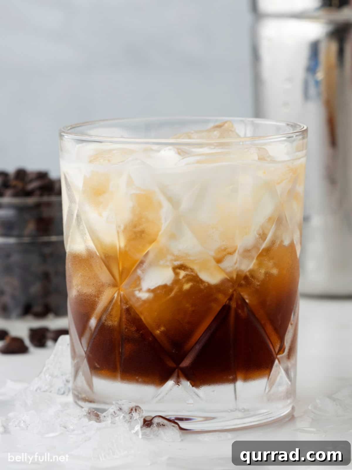 Velvet Nightcap 2 A perfectly swirled White Russian cocktail in a lowball glass, showing the creamy texture and rich coffee hue.