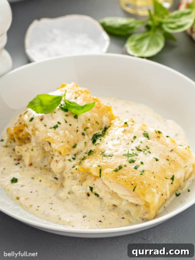2 chicken Alfredo lasagna rolls on a plate.