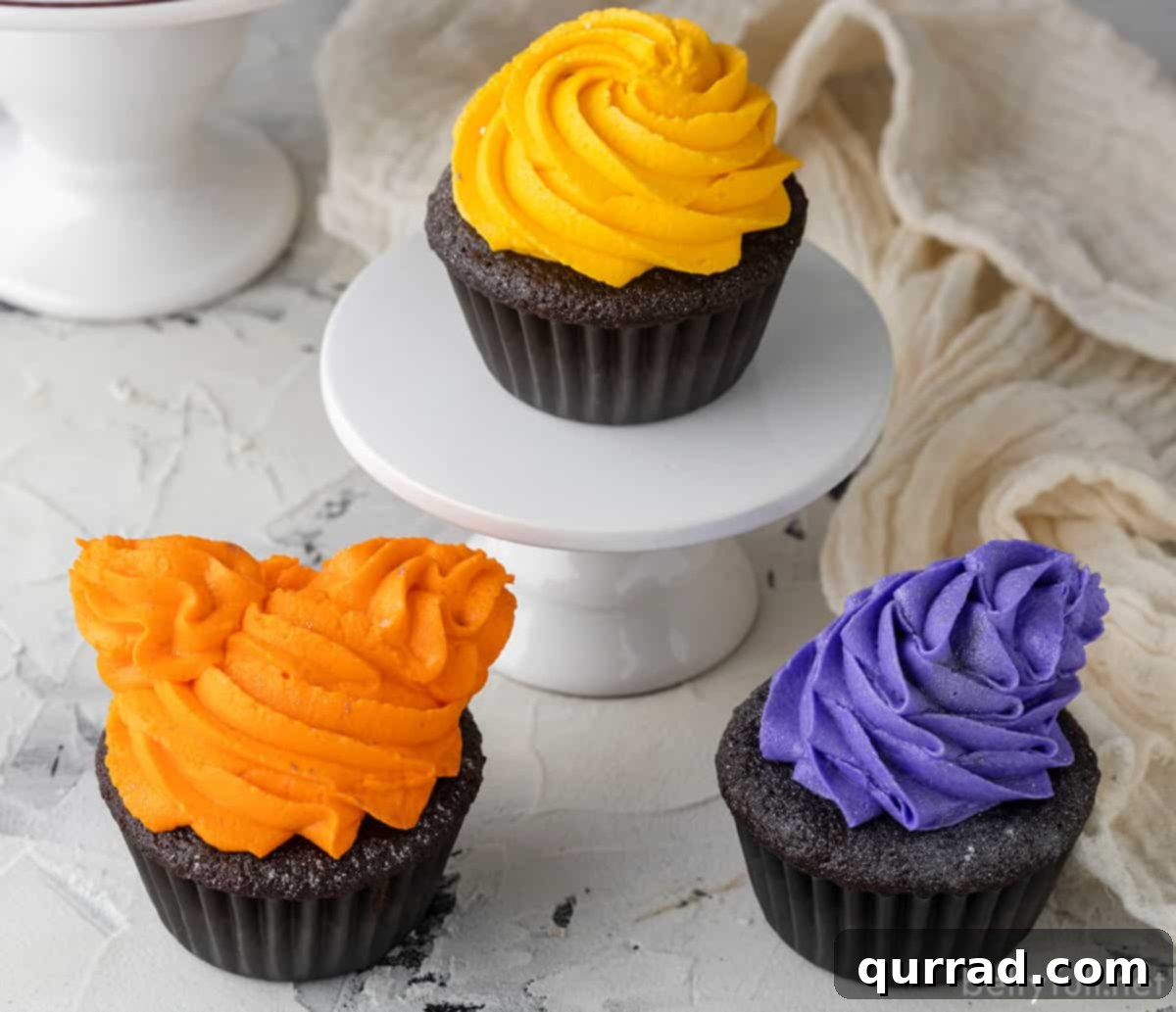 Bewitching Hocus Pocus Cupcakes 3 A close-up of multiple Hocus Pocus Halloween Cupcakes, showcasing the intricate piping of orange, yellow, and purple buttercream, ready for a festive celebration.