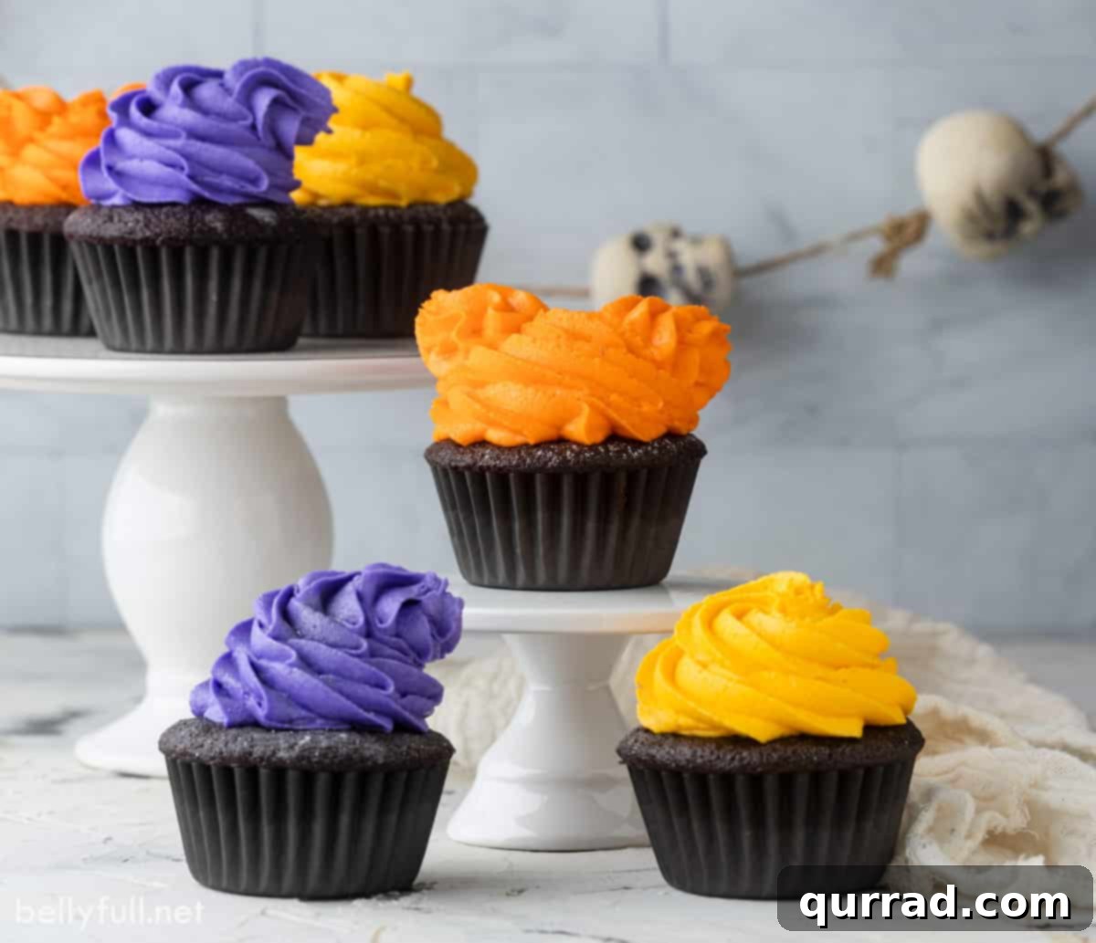 Bewitching Hocus Pocus Cupcakes 5 A trio of Hocus Pocus Halloween cupcakes, beautifully decorated with colorful buttercream and glitter, perfect for a spooky celebration.
