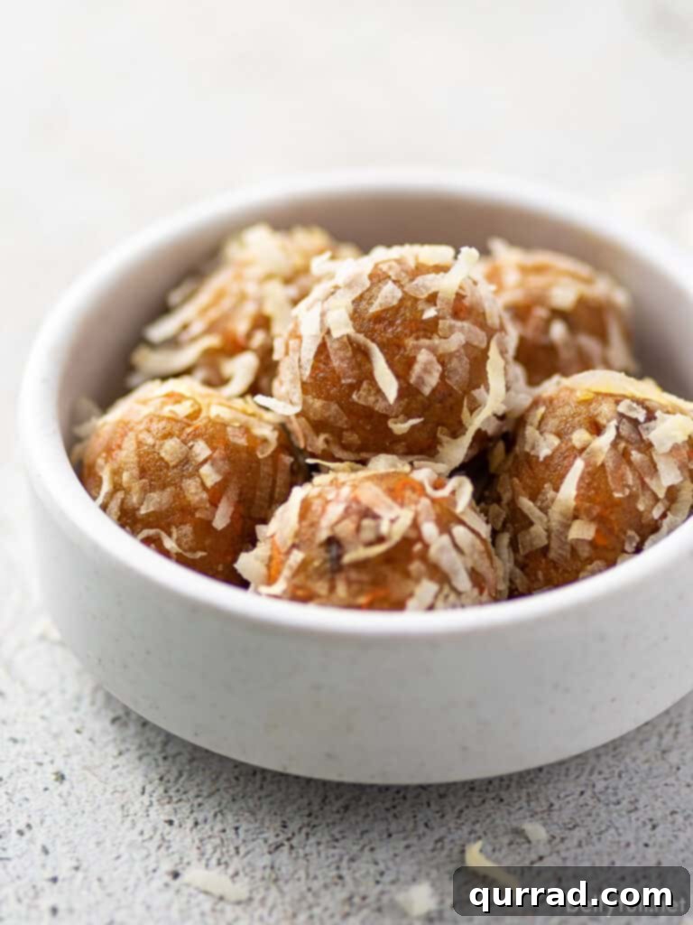 Carrot Cake Bliss Bites 4 A bowl of coconut flake-coated protein balls, ready to be enjoyed as a healthy and energizing snack.