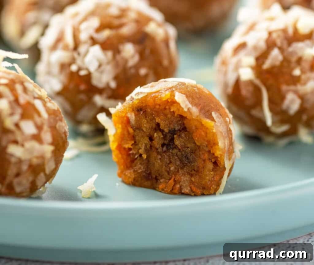 Carrot Cake Bliss Bites 5 A carrot cake protein ball cut in half to show its moist, dense interior and flecks of carrot.