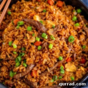 beef fried rice in black serving bowl with chopsticks