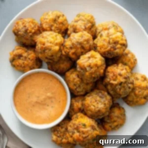 Delicious Cheddar Bay Sausage Balls on a platter with remoulade sauce, ready to be enjoyed.