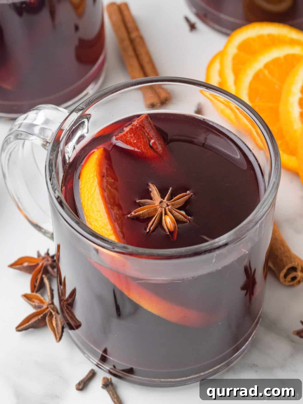 Spiced Winter Warmth 2 A beautifully garnished glass of mulled wine, showcasing its rich red color and festive spices.