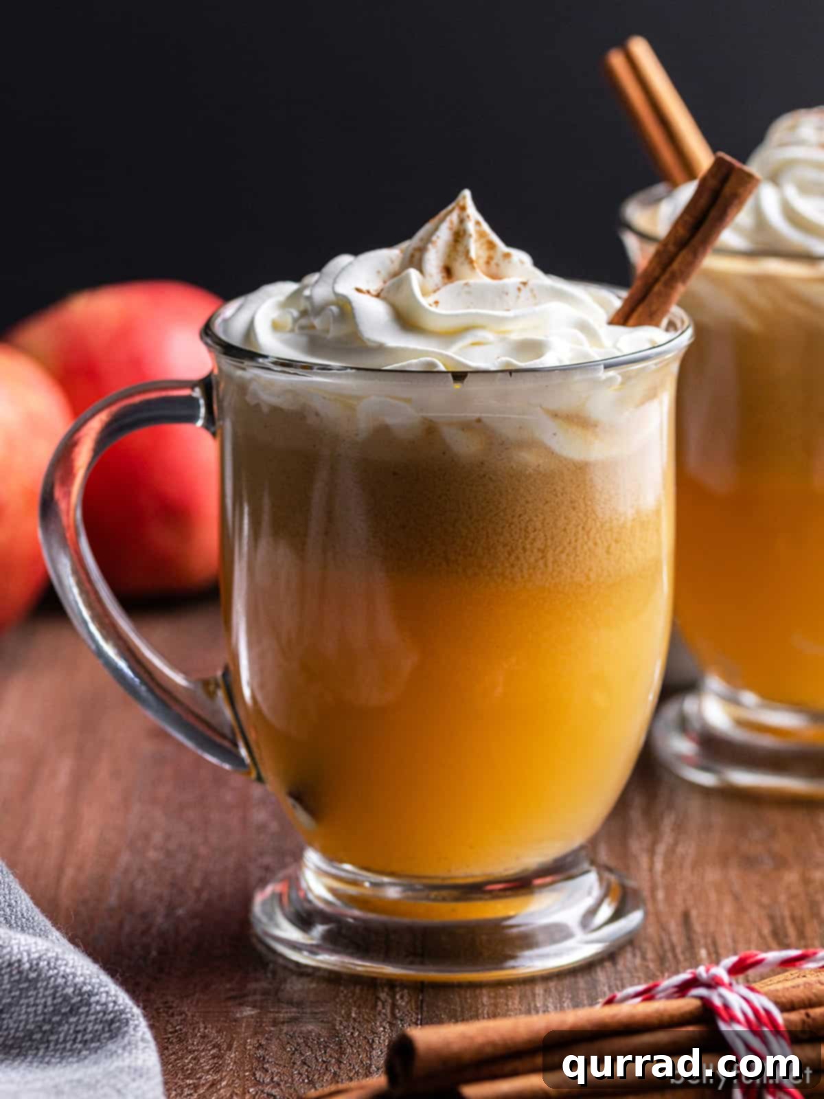 Fireside Golden Buttered Rum 2 A steaming mug of golden hot buttered rum, garnished with a fragrant cinnamon stick and a swirl of whipped cream.