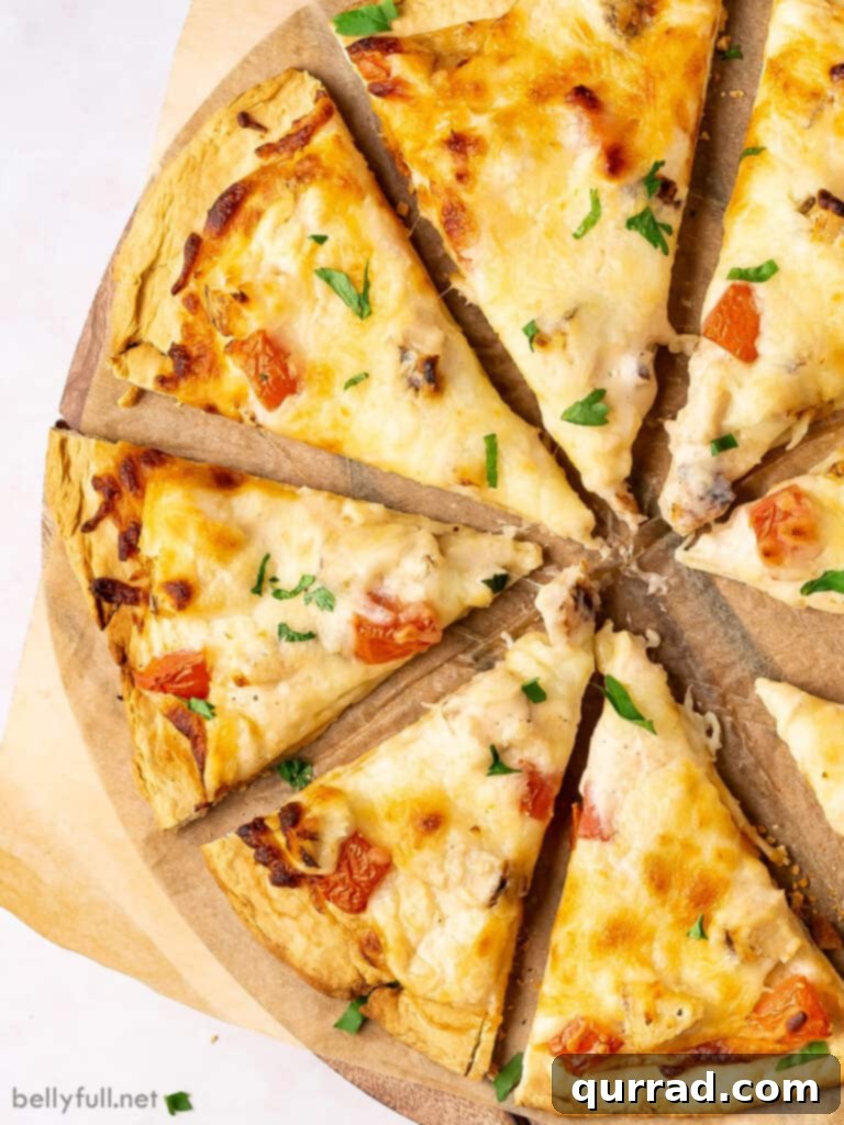 Creamy Chicken Alfredo Pizza 2 Close up slice of Chicken Alfredo Pizza showing creamy sauce, chicken, and melted cheese