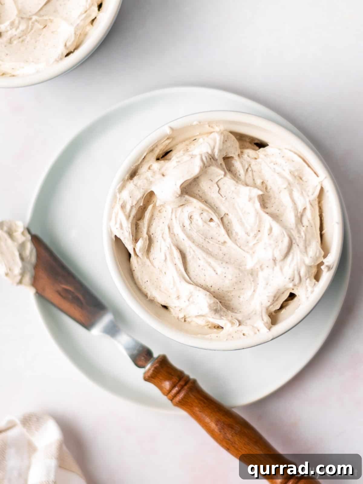 Maple Cloud Butter 3 Overhead view of whipped maple butter in a white ramekin, showcasing its creamy texture