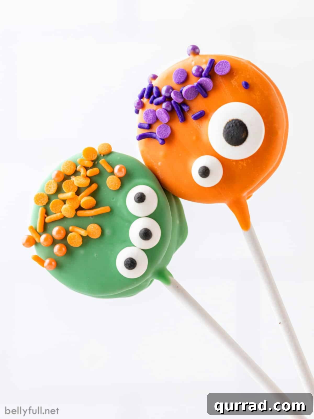 Ghoulish Oreo Cookie Pops 2 Two Halloween Oreo monster pops, one green and one orange, decorated with candy eyes and sprinkles