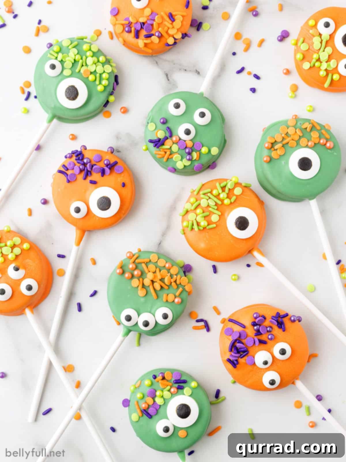 Ghoulish Oreo Cookie Pops 5 Overhead view of green and orange monster pops with various candy eyes and sprinkles