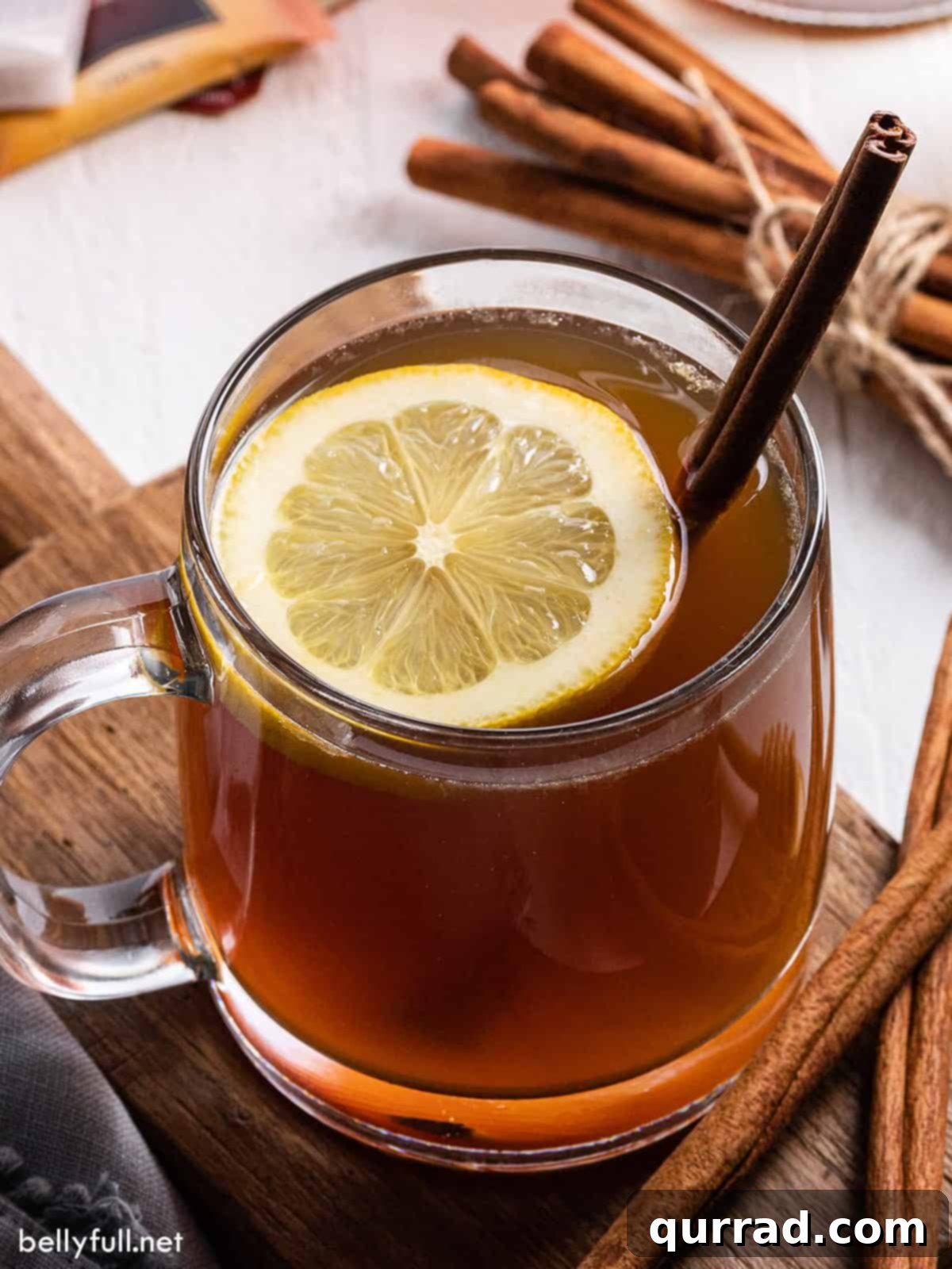 Spirited Winter Comfort 2 Close-up view of a hot toddy with a lemon slice and a cinnamon stick