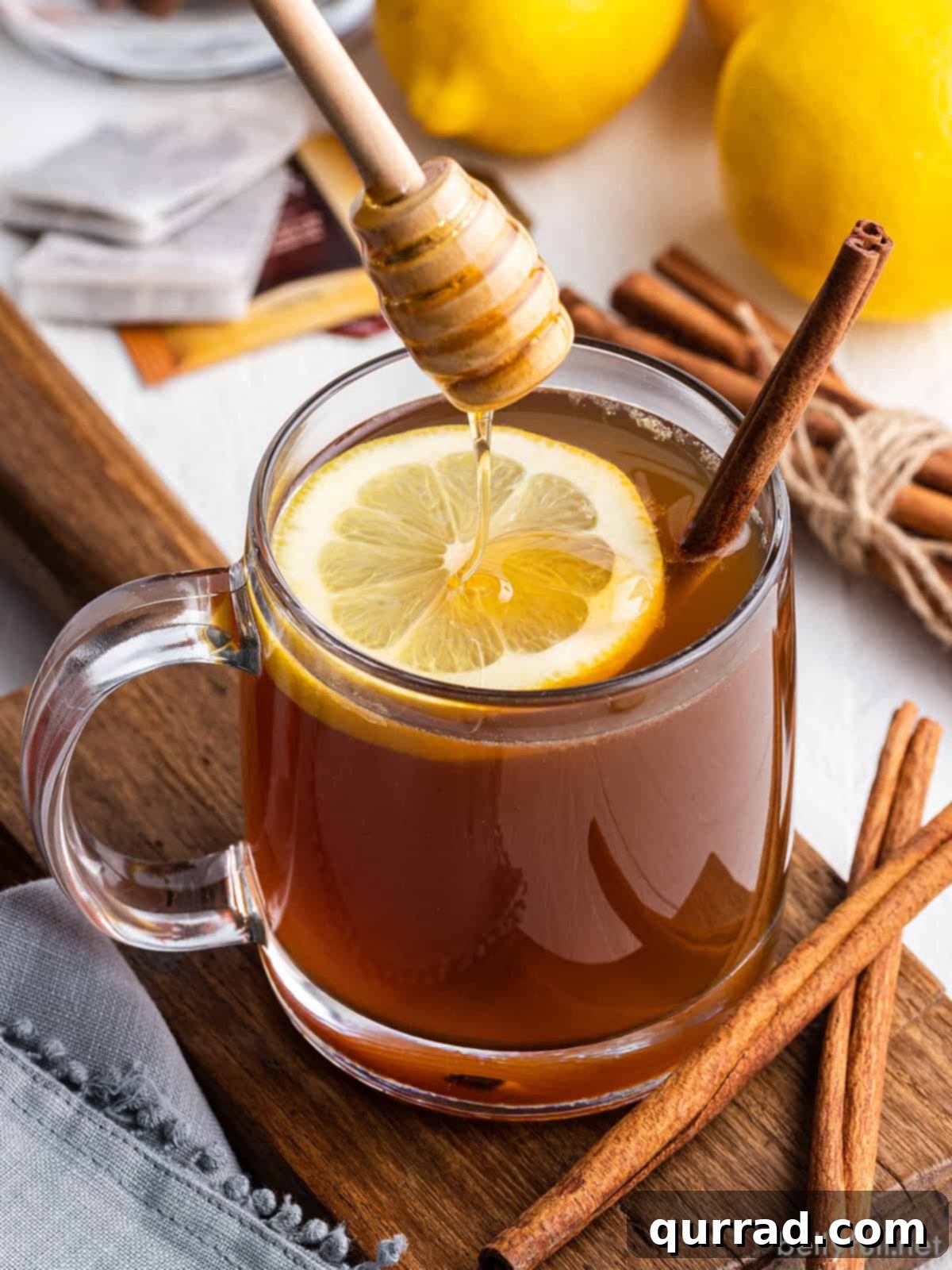 Spirited Winter Comfort 4 Honey being drizzled into a hot toddy