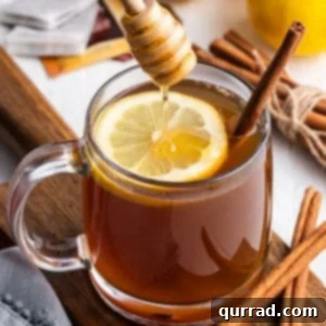 Honey being drizzled into a hot toddy