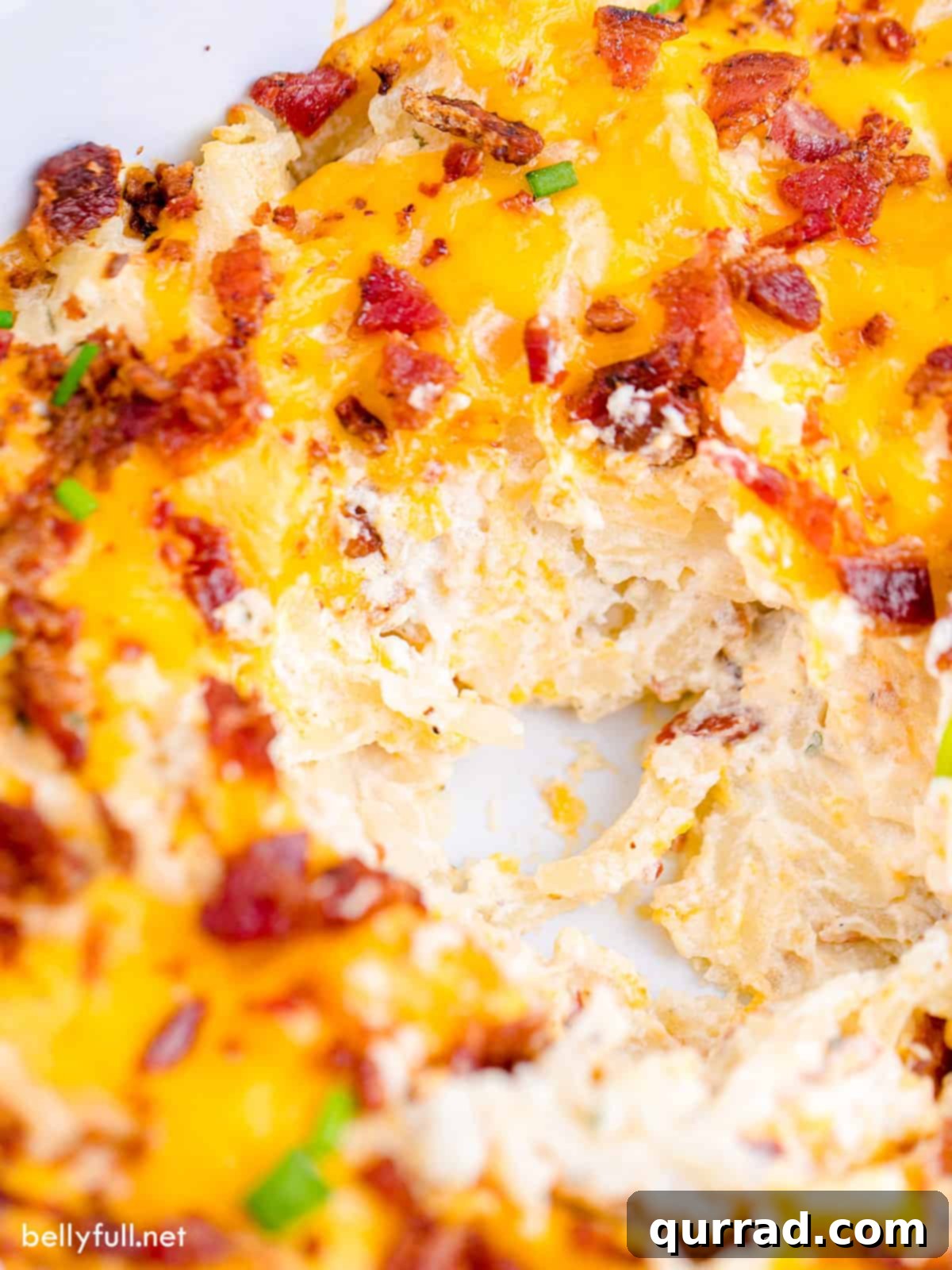 Golden Cheesy Potato Bake 3 A baking dish filled with cheesy potatoes casserole, bubbling and golden brown.