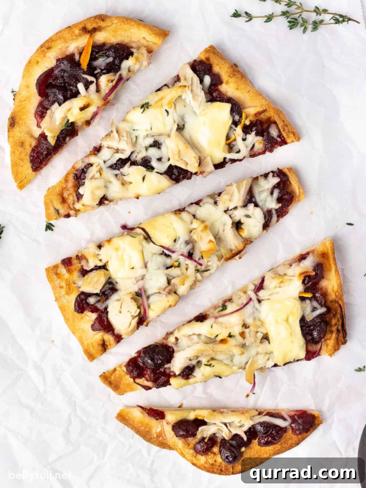 Overhead view of turkey cranberry brie pizza, showcasing the golden crust and melted cheese