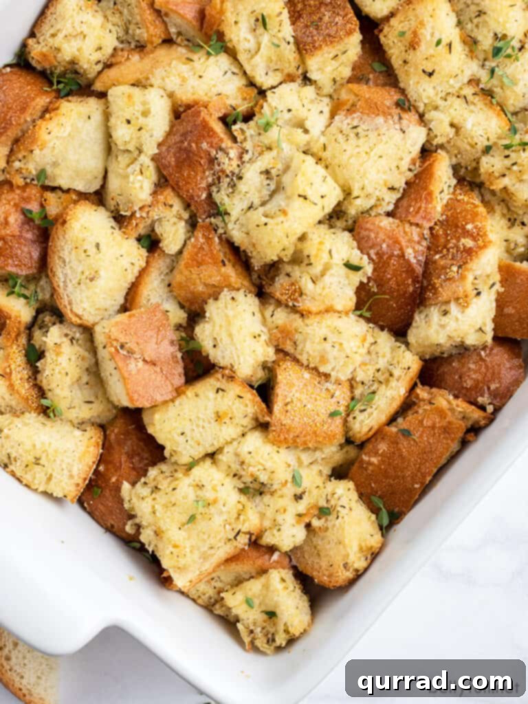 Nana's Simple Stuffing Recipe 3 Close-up overhead shot of golden-brown stuffing in a casserole dish, highlighting its crisp texture and savory appeal.