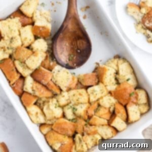 stuffing in casserole dish with wooden spoon