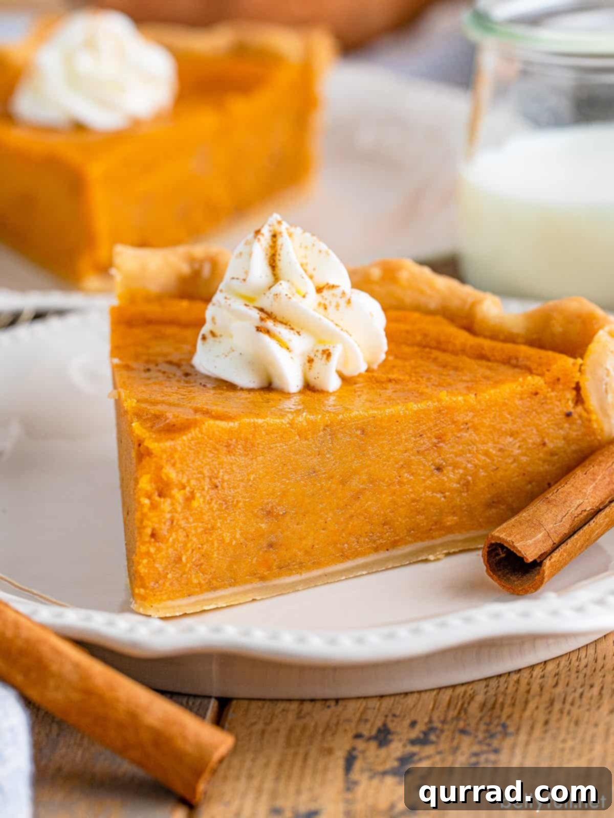 A slice of sweet potato pie on a white plate