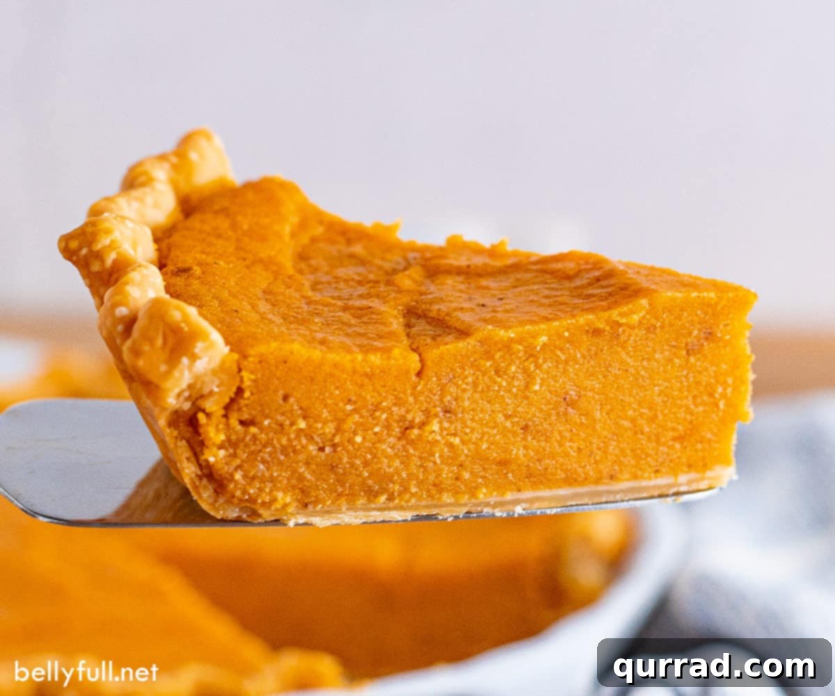 A slice of sweet potato pie being served from the pie pan