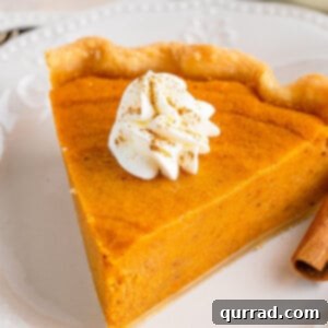 A slice of homemade sweet potato pie with a dollop of whipped cream