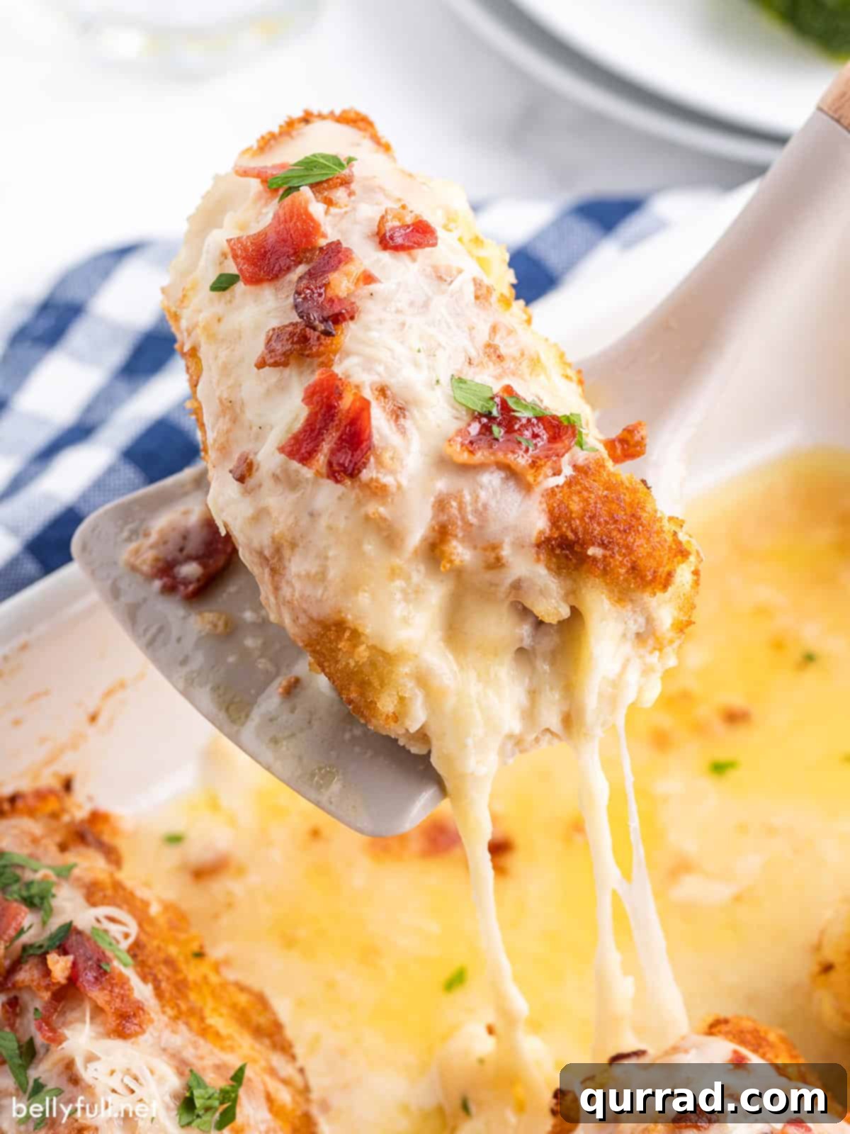 Golden Chicken Ham and Swiss 11 Chicken cordon bleu being served from a baking dish, highlighting the golden crust.