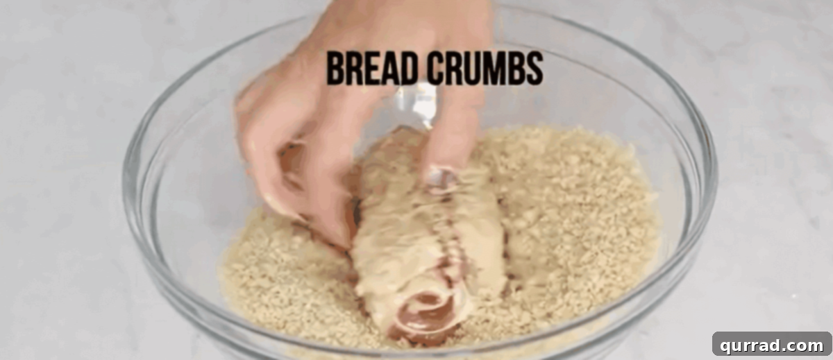 Golden Chicken Ham and Swiss 6 Dipping chicken in flour, egg, and breadcrumbs in a systematic breading station.