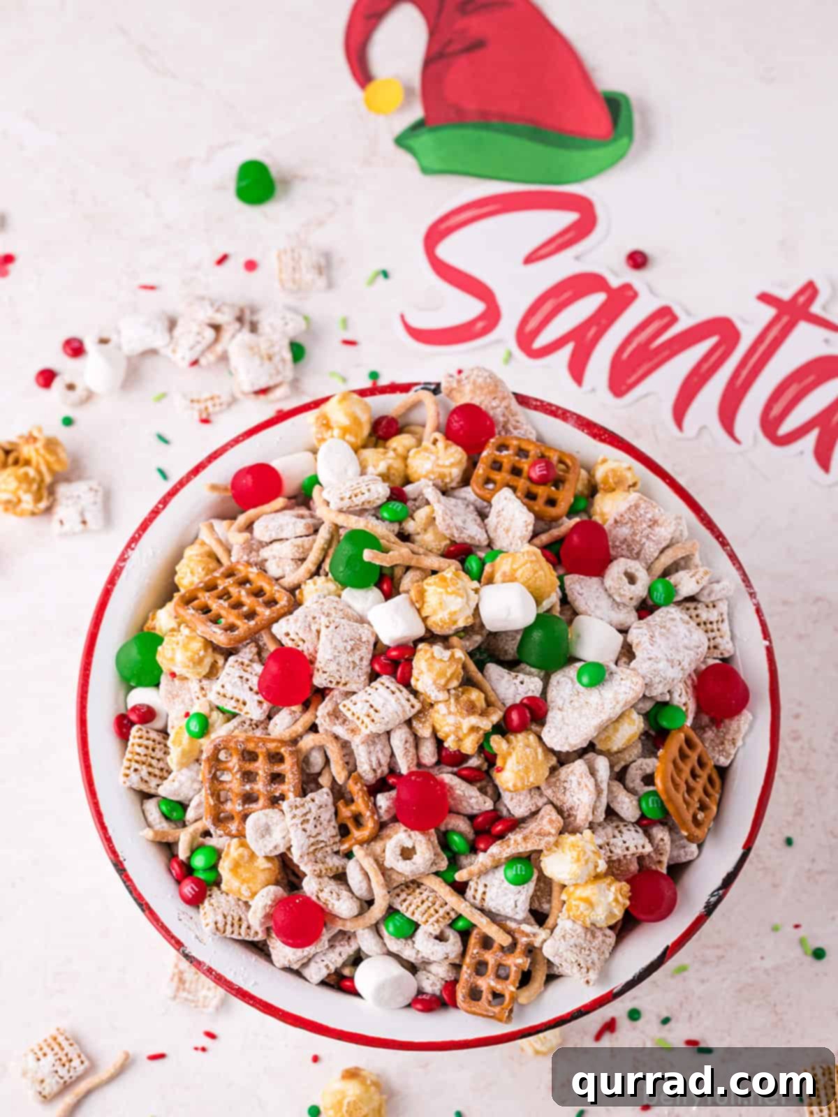 Reindeer Chow 5 A generous portion of freshly made Christmas Chex Mix presented beautifully in a large ceramic bowl, showcasing its festive colors and varied ingredients ready for serving.