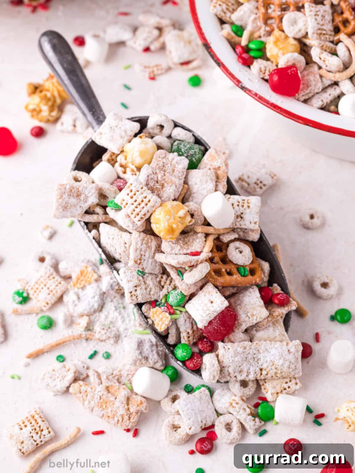 Reindeer Chow 6 A scoop overflowing with homemade Christmas Chex Mix, featuring a perfect blend of sweet, salty, and crunchy ingredients, ready to be enjoyed as a festive holiday snack.