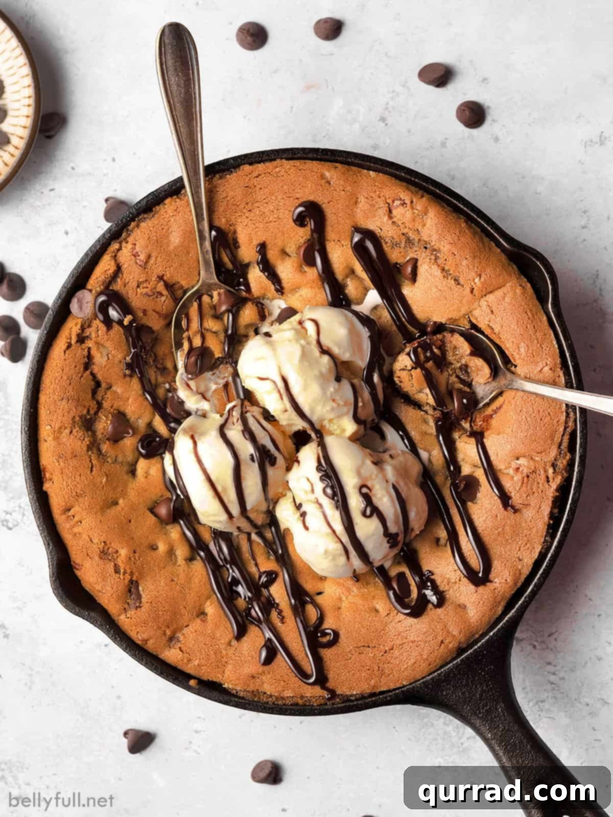 Overhead view of a chocolate chip skillet cookie, golden brown with melted chocolate