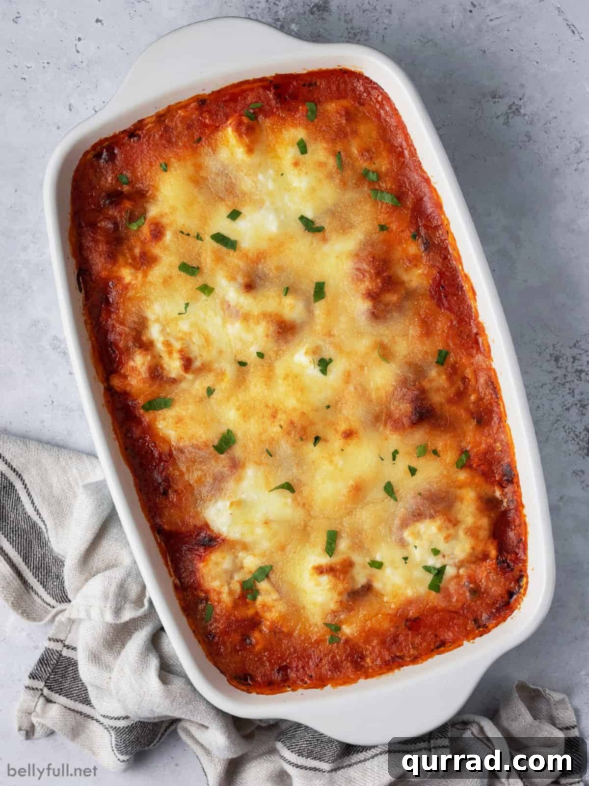 Cheesy Ravioli Dream 3 Overhead view of a freshly baked ravioli casserole, golden brown and bubbling.