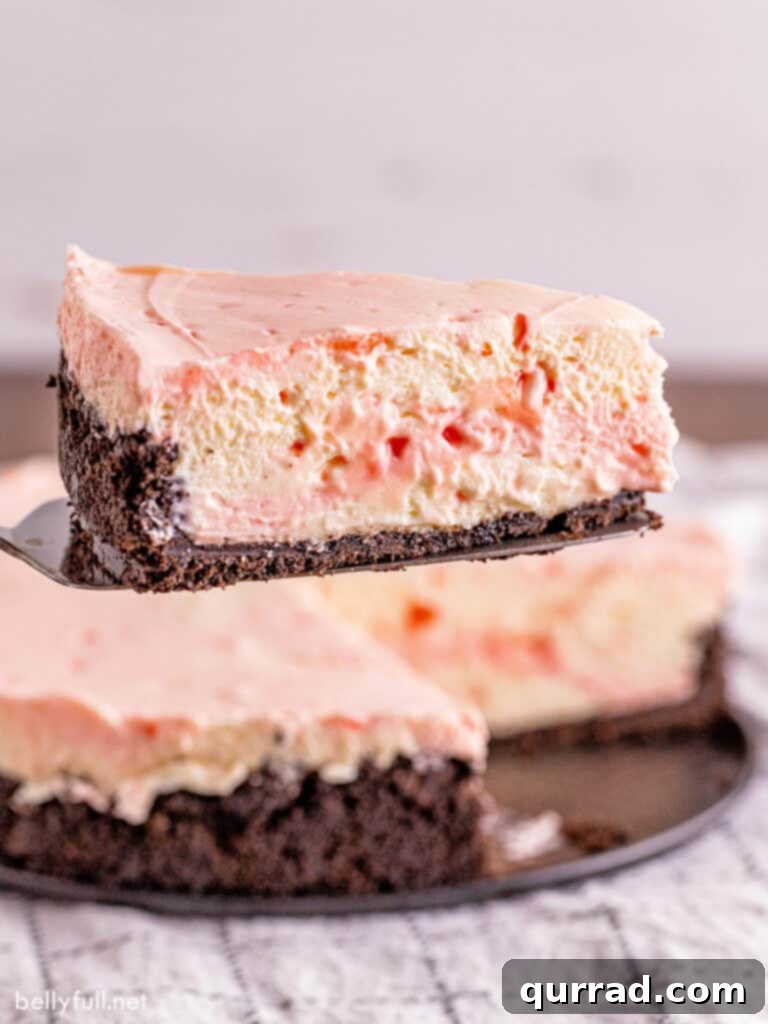 A side view of a perfect slice of peppermint cheesecake resting on a serving spatula, ready to be enjoyed.
