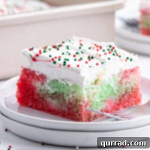 Jiggly Holiday Poke Cake 6 Square slice of Christmas Jello Poke Cake on plate