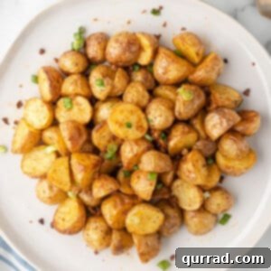 overhead pile of oven roasted potatoes on white plate