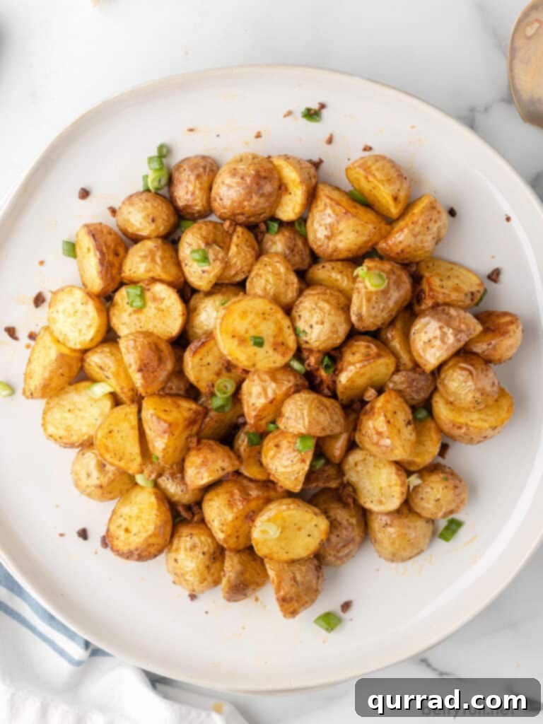 overhead pile of oven roasted potatoes on white plate