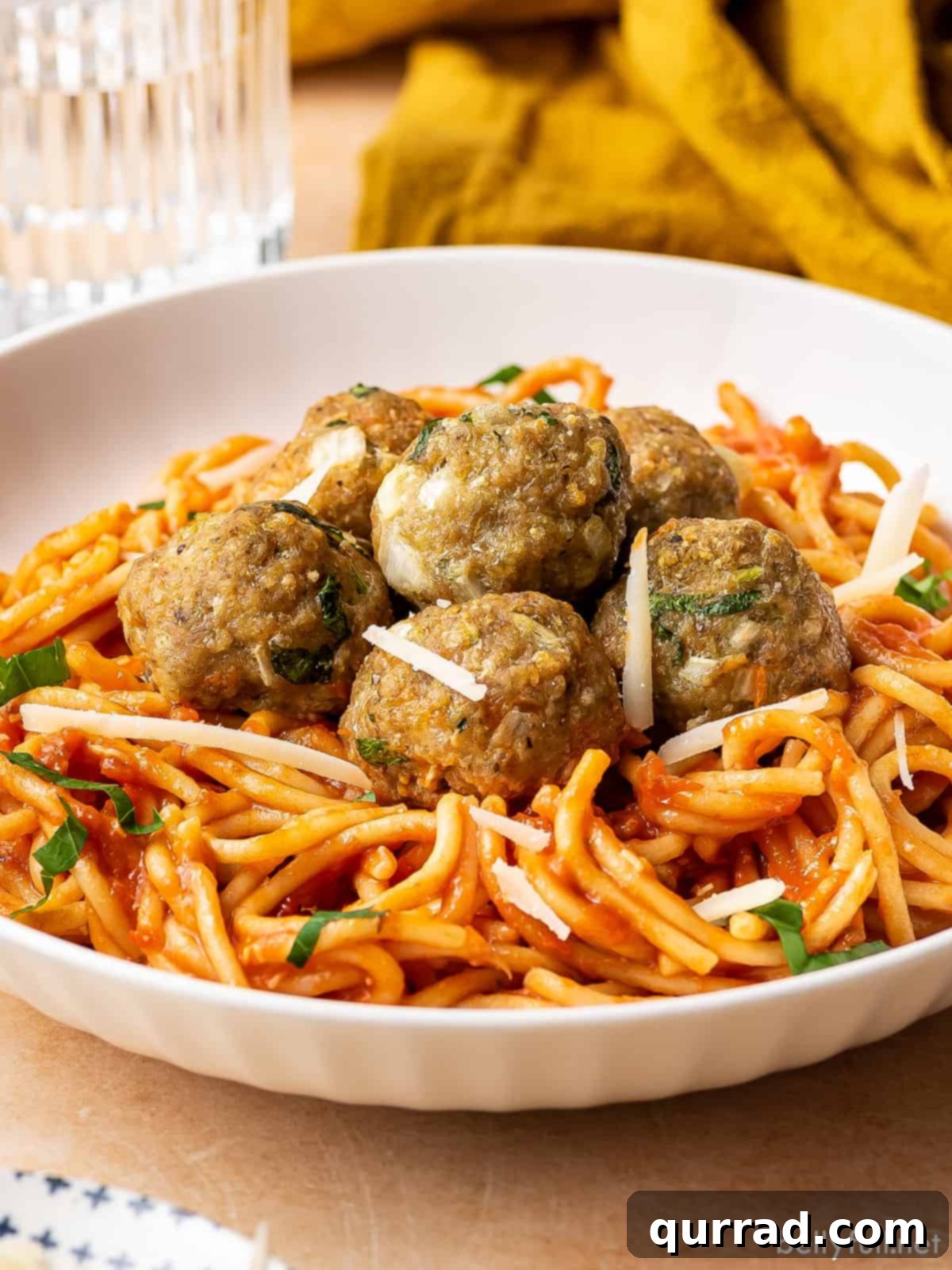 Savory Turkey Meatballs 4 Turkey meatballs on a plate of spaghetti