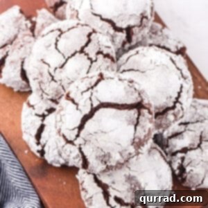 stack of Chocolate crinkle cookies on a brown serving board