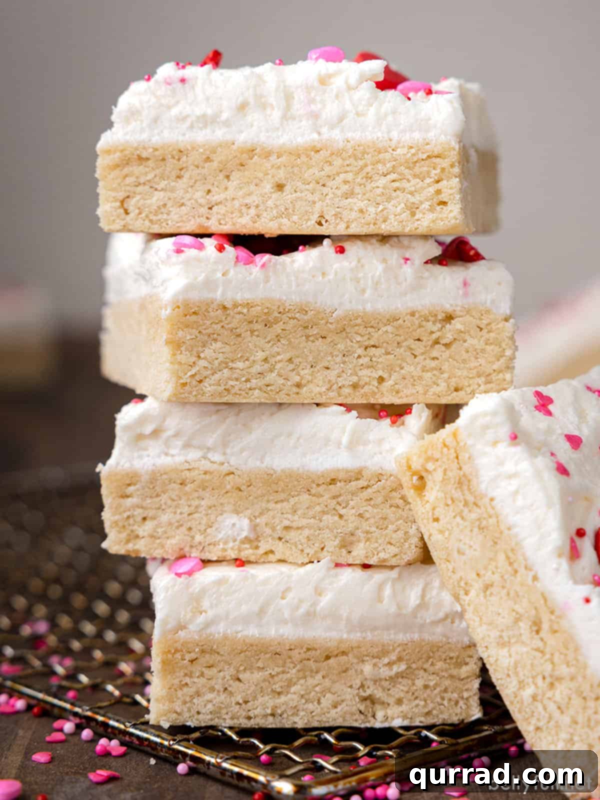 Soft Frosted Sugar Cookie Bars 3 A delectable stack of Frosted Sugar Cookie Bars, inviting you to grab a piece. The perfect easy dessert for sharing at any festive event.