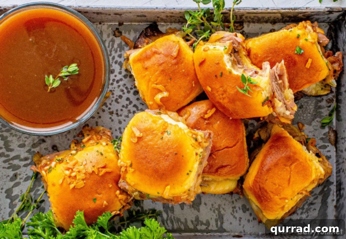 Irresistible French Dip Sliders 5 Overhead view of a platter full of French dip sliders
